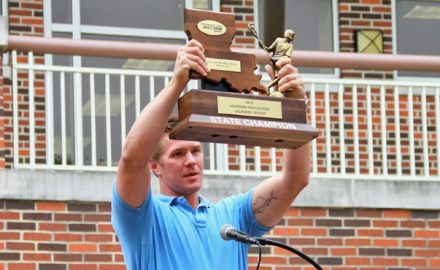 assembly_lacrosse-2015_-coach-w-championship-trophy_04272015_webhome