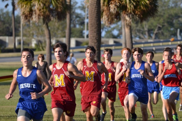 Sophomores Matthews Vargas (left) and Nathan Cusimano (center), along with junior Liam Fitzgerald (right) compete in the District Cross Country meet on November 2 at the Lakefront Course.