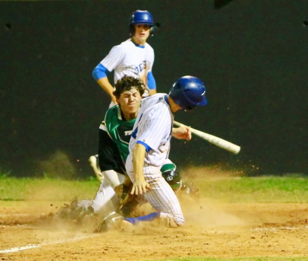 Senior shortstop Michael Cusimano slides safely into home during Jesuit’s district game against Grace King High School on Tuesday evening, April 2 at Bonnabel’s field. The Jays socked it to the Irish, 13-3, in a game called after the fifth inning because  of the 10-run rule.
