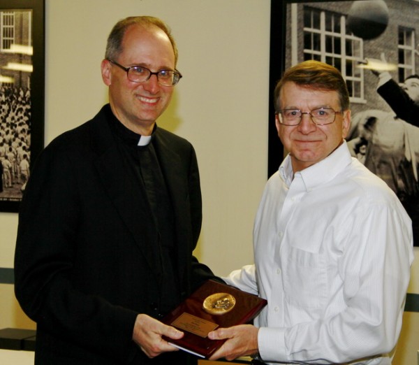 Fr. Raymond Fitzgerald, S.J., president of Jesuit High School, presents the fourth 2013 Profile Award to history teacher Mr. Ron Rossi.