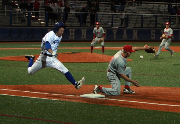 Great Hustle... Junior third baseman Brandon Sequeira (10) hustles on this infield hit and reaches first base on a Rummel error. More importantly, Jesuit scores what will be the winning run on this play.