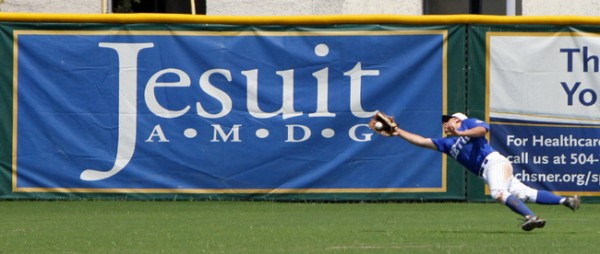 Retif Oil left fielder Clayton Deron ’14 makes a fantastic diving catch during the American Legion’s City Series championship game against Peake BMW (Brother Martin) on Tuesday afternoon, July 9, at Kirsch-Rooney Stadium.