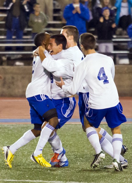 Jesuit' players mob teammate Sebastian Pereira-Pinzon, center, after he scored the winning goal for a  2-1 double-overtime victory over St. Paul's for the Division I soccer state championship Saturday, Feb. 23, 2013, at Tad Gormley Stadium.