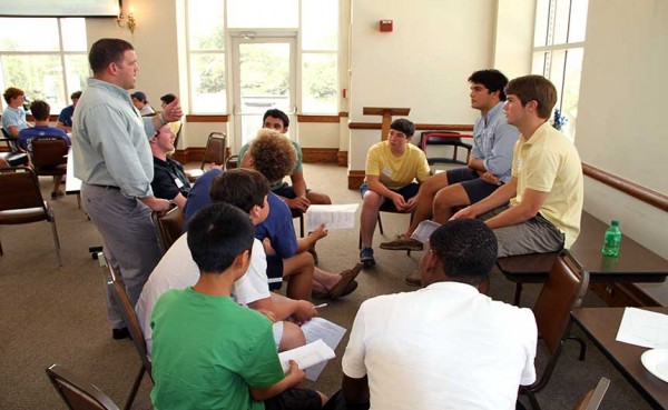Student activities director Matt Orillion ’98 helps students formulate action plans during the St. Francis Borgia Leadership Institute Workshop on Wednesday, July 31 in St. Ignatius Hall.