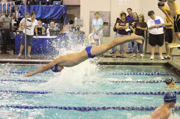 unior Brett Dipuma dives into the 200 medley relay which ended in a photo finish with Jesuit in second place. 