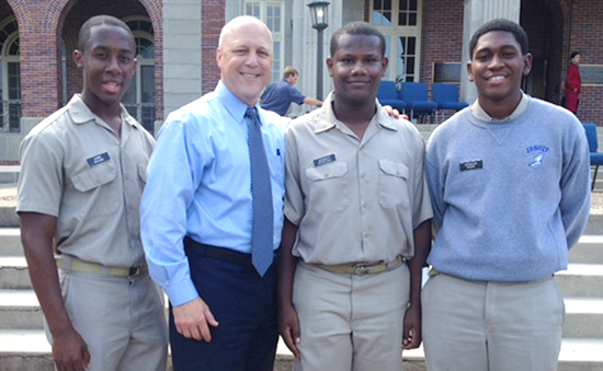 Seniors Christopher Sylvain, Herbert Spurlock, and Brandon Myers visit with Mayor Mitch Landrieu ’78 at the Archdiocese of New Orleans’ prayer service celebrating the 50th Anniversary of the March on Washington.