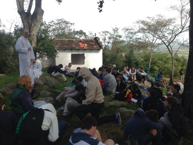 Fr. Raymond Fitzgerald, S.J., celebrates Mass after the stations of the cross on the top of a hill. 