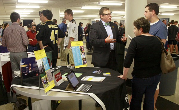 At the 2012 College Fair Night, a representative from Oglethorpe University visits with a Blue Jay and his mother.