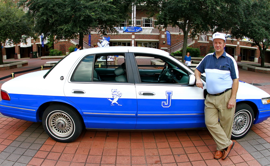 Mike Waldo of the Class of 1970 pushed Jesuit and Pensacola (where he lives with his wife Judy, seated under the oak) to renew their long-dormant high school football rivalry. To celebrate the first game since 1966, Waldo bought a Mercury Grand Marquis and had it re-painted Jesuit Blue & White. He drove to New Orleans Thursday evening and parked the "Jaymobile" in the Traditions Courtyard, the setting for a lunchtime pep rally on Friday.
