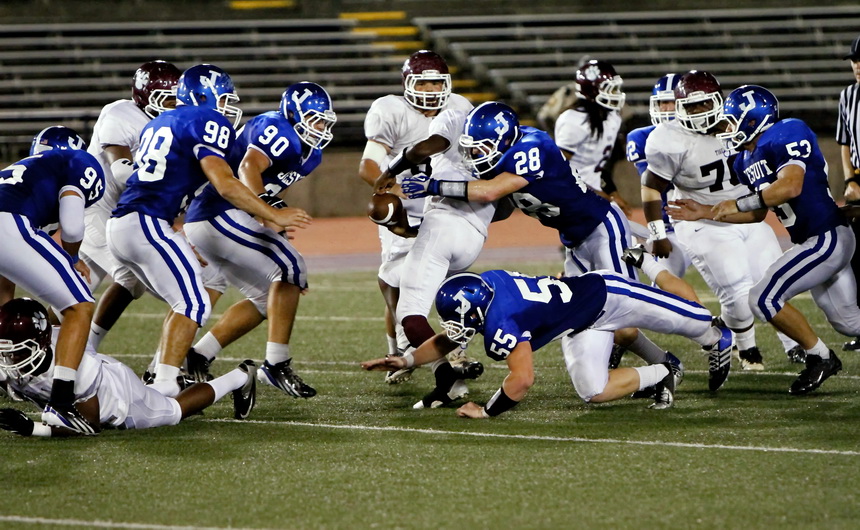 Juniors Dillon Knight (28) and linebacker Robert Lobrano tackle this Tiger runner who is in the process of losing the football. The Jays recovered the fumble.