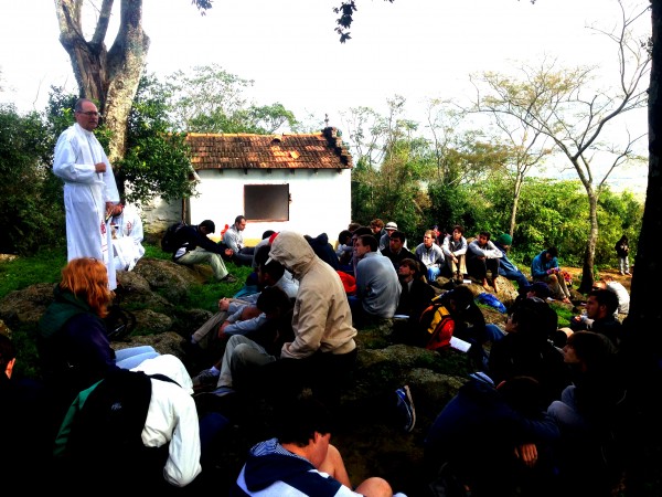 Fr. Raymond Fitzgerald, S.J '76 (far left), Jesuit's president, accompanied the pilgrims, regularly leading them in prayer, here at an outdoor Mass in Paraguay. Photo by Mr. Jeremy Reuther.