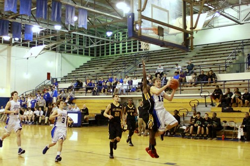Senior Grant Nichols makes a shot against the St. Amant Gators in Thursday's 77-57 win in the Birdcage.