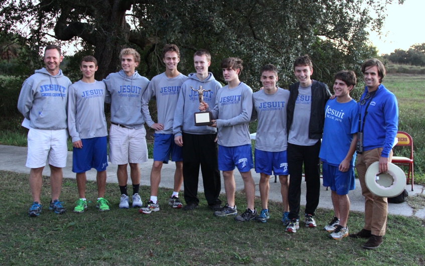 Members of the Blue Jay Cross Country team holding their district championship  trophy