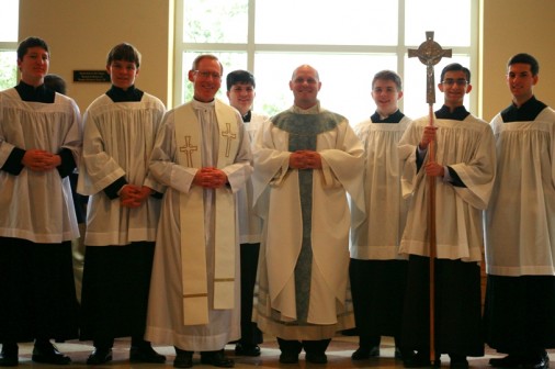 Altar servers join Fr. Don Saunders, S.J. (left) and Fr. Nile Gross, an alumnus from the Class of 1995, after a Mass celebrating the Feast of the Immaculate Conception in the Chapel of the North American Martyrs. 
