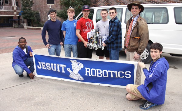 The Robotics Club gathered for a photo before boarding a Texas-bound van Tuesday evening. Clockwise from lower left are sophomore Bryan Jones; alumnus and co-moderator Mel Triay ’03; junior Steven Stradle;, freshman Todd Crabtree; junior Michael Belanger; freshman John Crowson; moderator, coach, and science teacher Kyle White; and junior Michael Riddick. Not pictured is co-moderator Eric Leefe, who is an alumnus from the Class of 2003. 