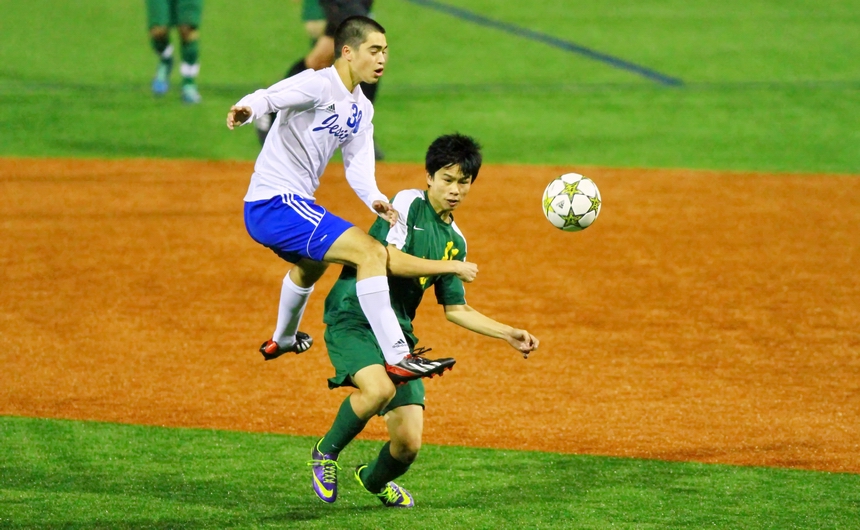 Chase Rushing reaches the ball first but feels a Bulldog encroaching on his space in Jesuit's regional playoff game against Baton Rouge High on Thursday evening at John Ryan Stadium.