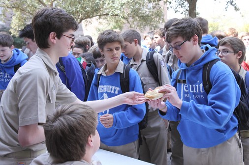Senior Alex Scalco hands a pretzel to sophomore Cody Capps Friday during lunch. More than 225 Blue Jays participated in the Pretzel Fast.