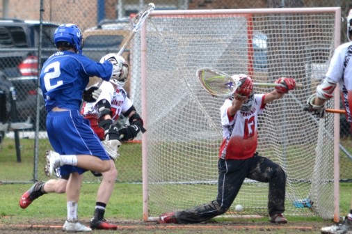 Junior Michael Simon goes low to score against Lafayette on Saturday, March 29. The Blue Jays won the game, 24-0.