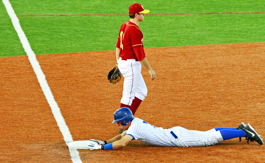 Scott Crabtree belly slides safely to third base after hitting a ball deep into right-center field for a triple.