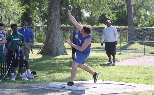 Senior Mikey McCombs throws the shot put. McCombs secured third place in the event, with a throw of 40-01.00.