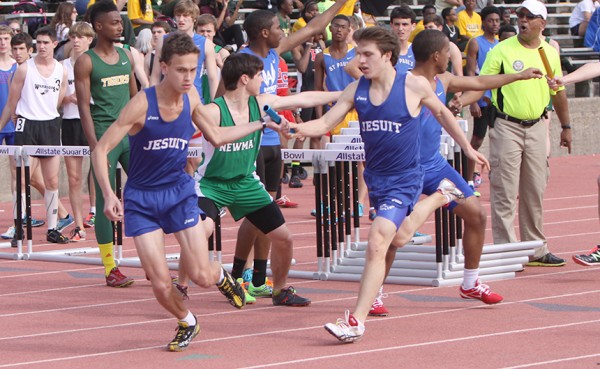 At the Allstate Sugar Bowl Track & Field Classic on March 22, senior Sean Stephens gets the baton from junior Michael Schwing as the two compete in the 4x800 meter relay.