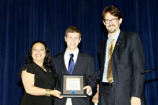 Senior Kevin Yokum is presented the St. Aloysius Gonzaga Award for the Member of the Year by co-moderators Ms. Nilda Rivera and Mr. Andrew Dykema. Yokum received several other awards during the ceremony, including the Frank T. Howard Memorial Awards for English and Physics and The Jesuit 500 Club Award, among others.