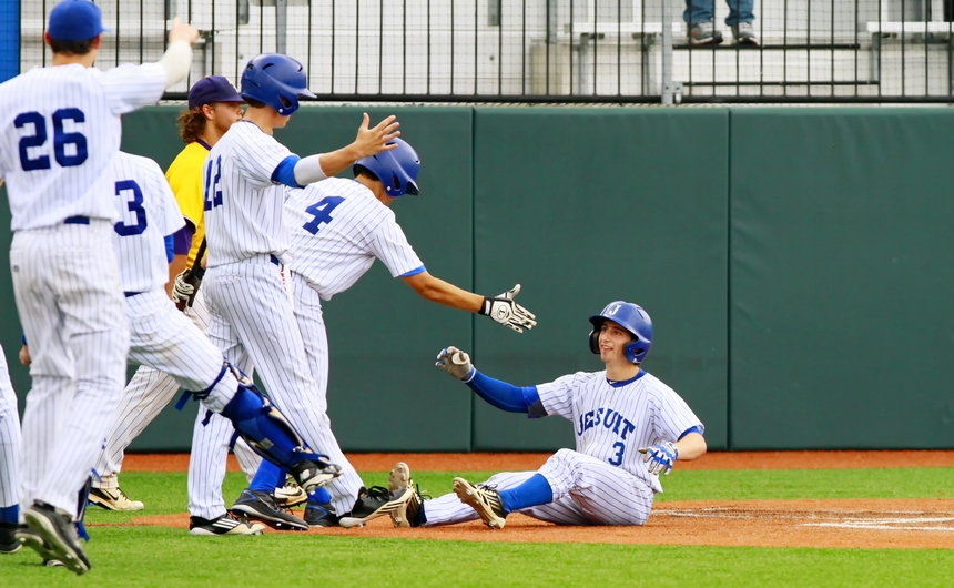 Blake Baker is greeted by his teammates after hitting an inside-the-park home run in Game 2 of Jesuit's quarterfinals "Best of 3" series against Alexandria. The Jays won Game 1 (4-3) and shutout the Trojans in Game 2, 8-0, to earn a trip to Sulphur next weekend for the LHSAA state baseball tournament.