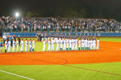 Blue Jays, Tigers, dignataries, and fans face the flag for the National Anthem prior to the start of the first game at John Ryan Stadium on Friday, March 2, 2012. 