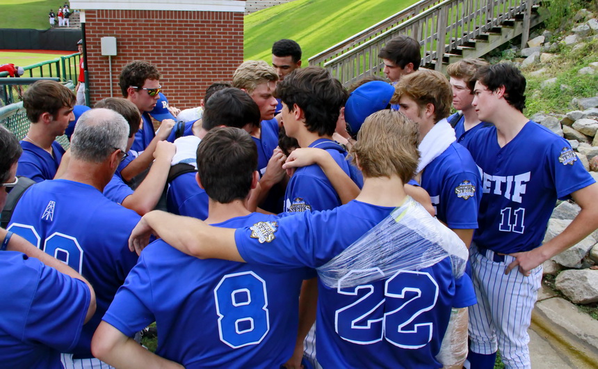 The final prayer of the season: Retif Oil players and coaches gather for some final words before departing Little Rock.