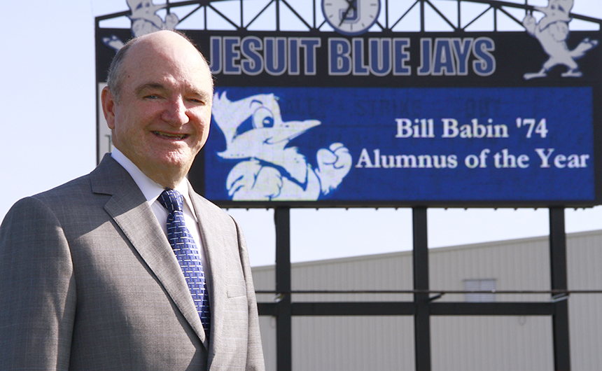 Bill Babin '74 stands on Alumni Field at John Ryan Stadium. As Jesuit's 57th Alumnus of the Year, Babin will receive the F. Edward Hebert Award during Homecoming Mass on Saturday, October 4 at 5 p.m. in the Chapel of the North American Martyrs.