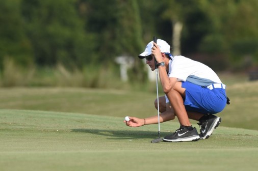 Freshman J.T. Holmes lines up a putt against Shaw on Tuesday, Oct. 7, at Lakewood Golf Club.