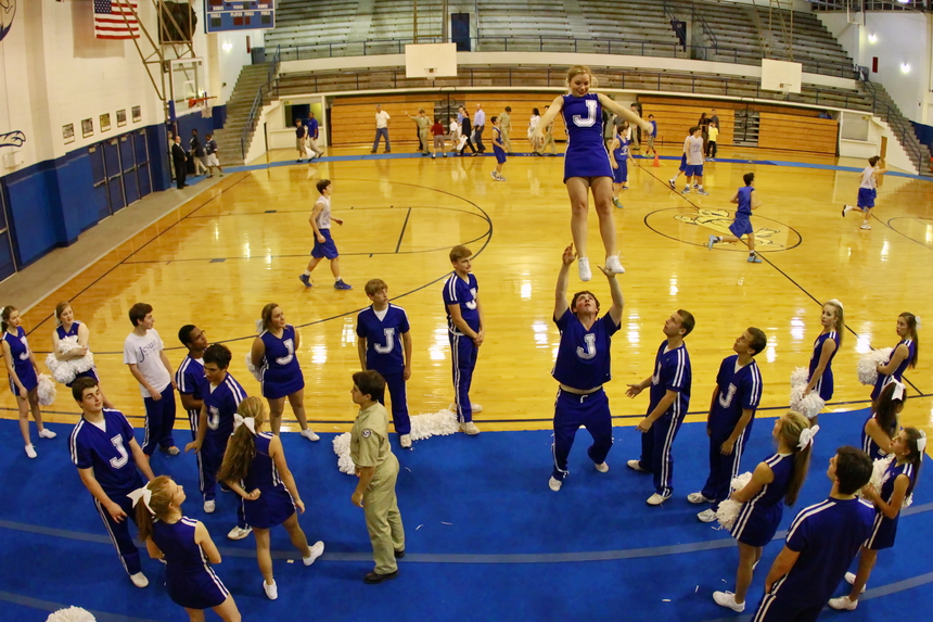 As tour guides led their guests through the gym (aka: the Birdcage), the Blue Jay basketball team had a full court scrimmage taking place while the Jesuit cheerleaders refined their techniques. Senior Niko Ros is prepared to catch his "flyer," Rebekah Besselman, a senior at St. Mary's Dominican High School.