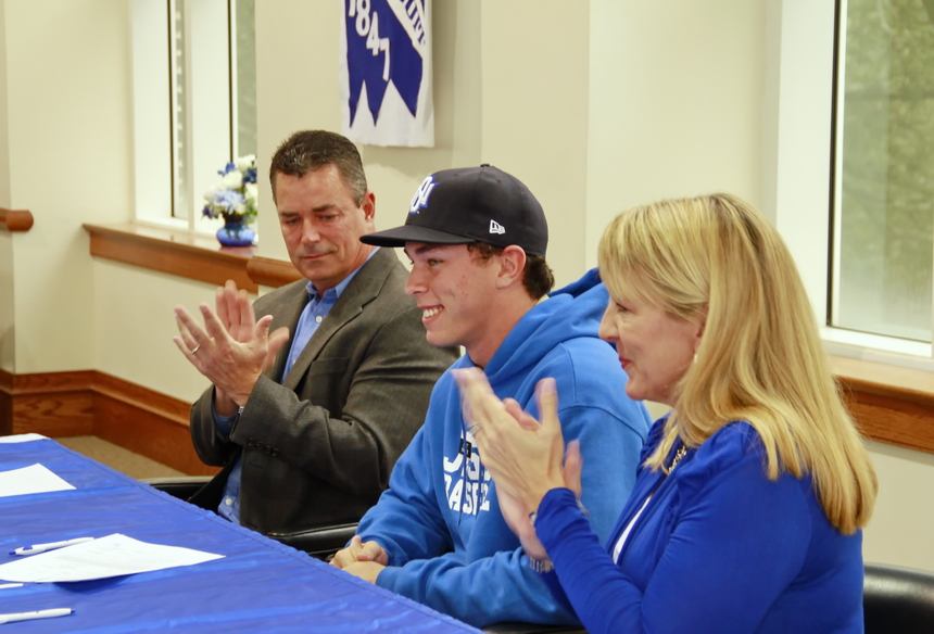 Flanked by his parents Skip and Breni Crabtree, Scott flashes that beamish smile moments after putting ink on his letter of intent to play baseball at UNO.