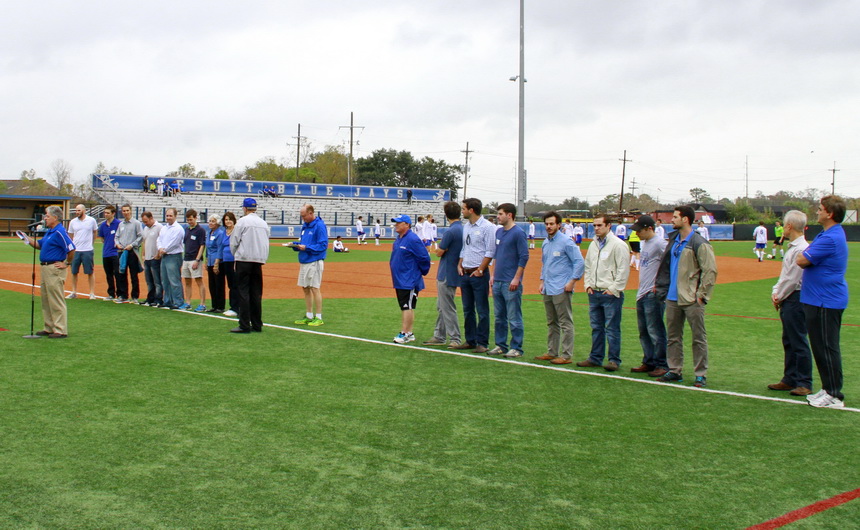 Jesuit alumni director Mat Grau '68 introduces some of the players and their stand-ins from the state championship teams of 1995 (on the left) and 2005.