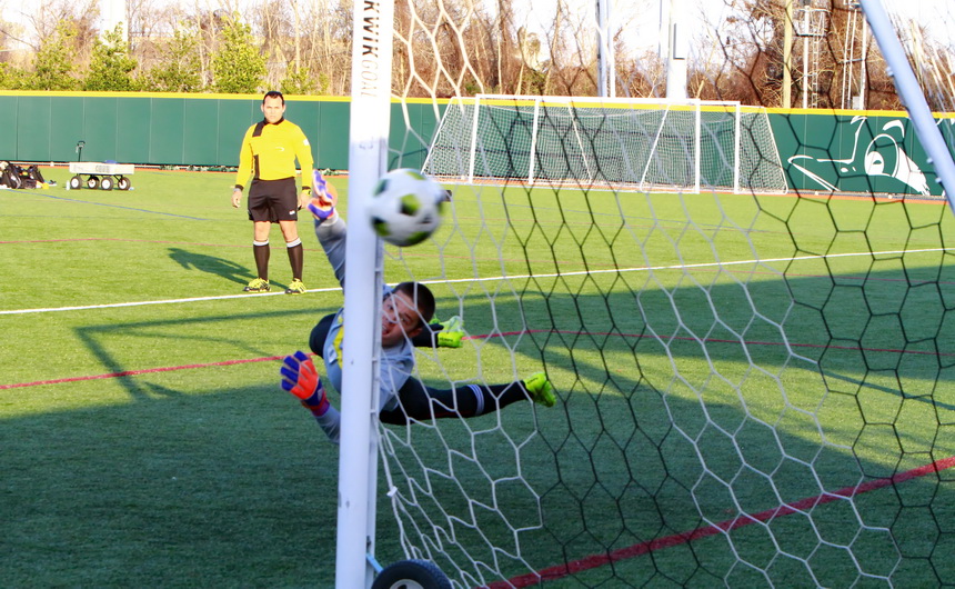 Jesuit goalkeeper Otto Candies goes horizontal in an effort to put a glove on Brother Martin's first penalty kick, which just missed going into the goal.