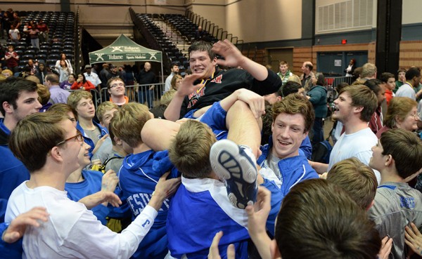 Fans and members of the wrestling team lift state champion Dominic Carmello (285) up on their shoulders following the conclusion of the state wrestling tournament Saturday, Feb. 21.