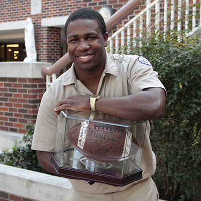 Senior running back Charles Jackson displays the team-signed state championship ball that will be auctioned off at the Blue Jay Bazaar. Jackson was recognized as the state championship game’s Most Outstanding Player. 