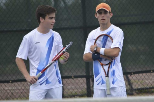 Junior Brandon Beck confers with his partner, Gregory Suhor. The duo set the tone on Tuesday with an exceptionally quick win at Line 1 doubles.