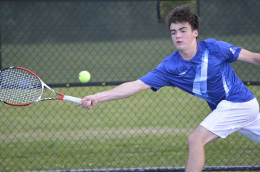 Junior Brandon Beck chases down a forehand in doubles competition against Newman on Thursday, March 19.