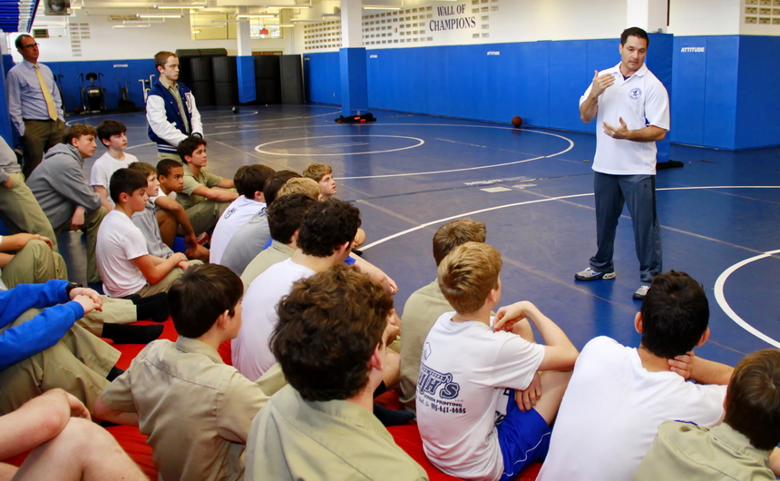 Spencer Harris, head coach of Jesuit's wrestling program, meets with some of the team after exams Tuesday, to inform them that he has decided to give up his coaching job to devote more time to family and fatherhood.