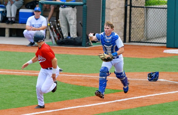 Catcher Trent Forshag attempts to run down a Rebel in Saturday's game. The runner made it safely back to third base.
