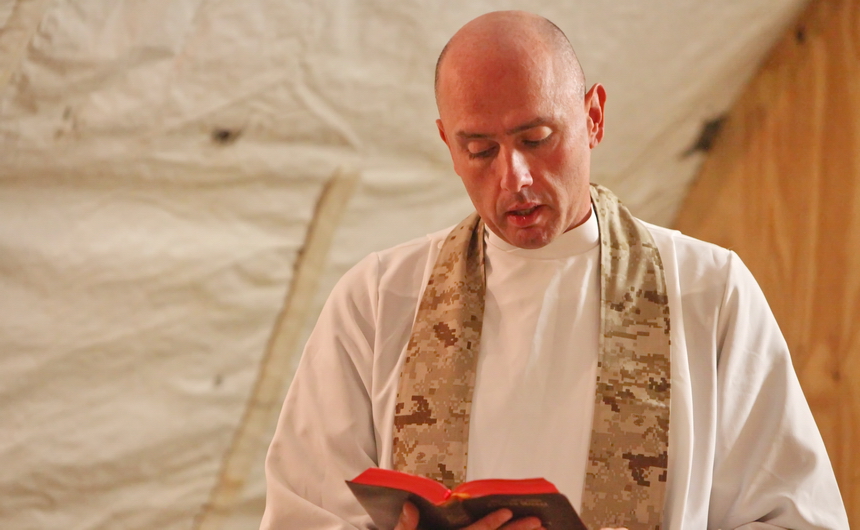 Fr. Christopher Fronk, S.J. reads during a Mass for soldiers on the front line Afghanistan. The photo was taken about two years ago.