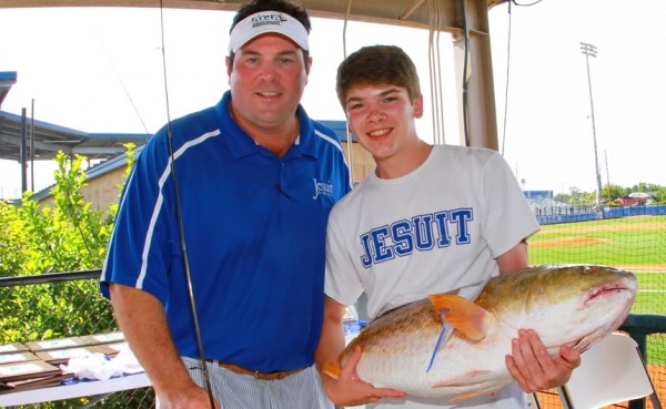 Blue Jay Fishing Rodeo chairman Mike McMahon '85 congratulates William Martin for hauling in the largest fish, a 28-pound bull redfish. Martin will be a pre-freshmen at Jesuit when the 2015-16 school year begins.