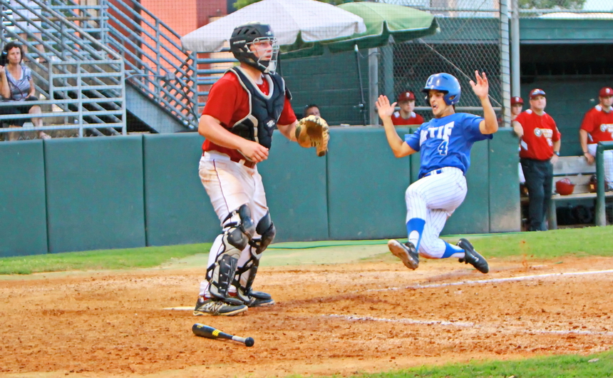 Alex Galy goes airborne and slides home safely to give the Retif Oilers a 5-4 win against Peake BMW and the American Legion District 1 championship.