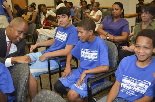U.S. Attorney chats with 7th-grader Gavin Lewis at the graduation ceremony. Lewis is flanked by Kyle Raterman to the left and Nehemiah Prater to the right.