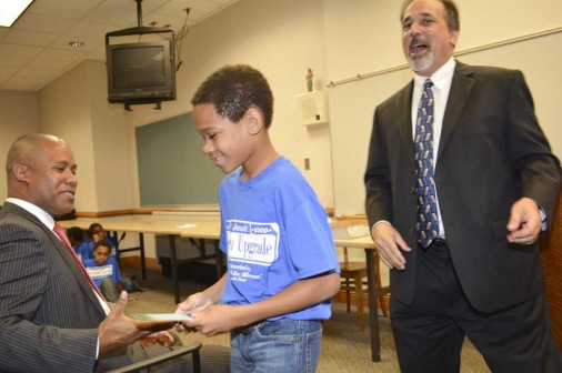 Upgrader of the Year Nehemiah Prater of Lake Castle Charter School is congratulated by U.S. Attorney Kenneth Polite.