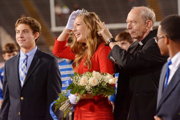 The senior maid elected as Queen by Jesuit's Class of 2016 is Amelia Haydel, who is escorted by Will Hurley. Fr. Anthony McGinn, S.J., president of Jesuit High School, helps adjust the Queen's crown.