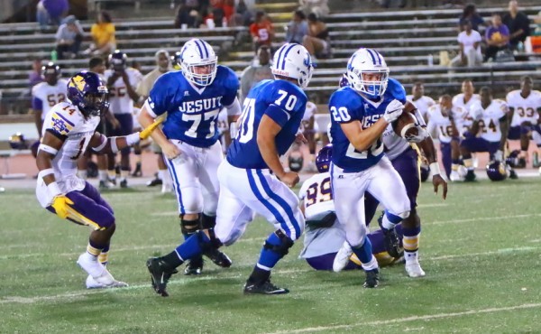 With Cullen Unsworth (77) and Benji Creel (70) looking out for him, Jesuit's work horse Connor Prouet picks up a first down in the fourth quarter.