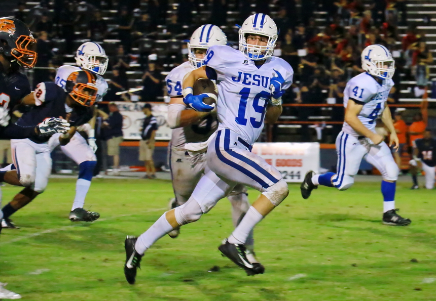 Defensive back Patrick Spiers runs back an interception in the waning moments of Jesuit's Friday night win against Escambia, 28-17.