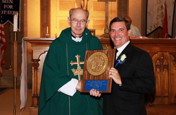 Fr. McGinn presents the F. Edward Hebert Award to the outstanding alumnus of 2015, John E. O'Shea, Jr. of the Class of 1980.